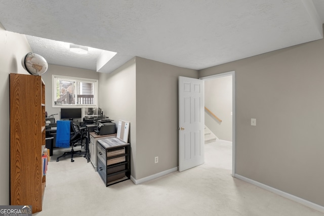 office with carpet, a textured ceiling, and baseboards