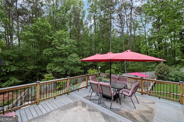 wooden terrace featuring outdoor dining space