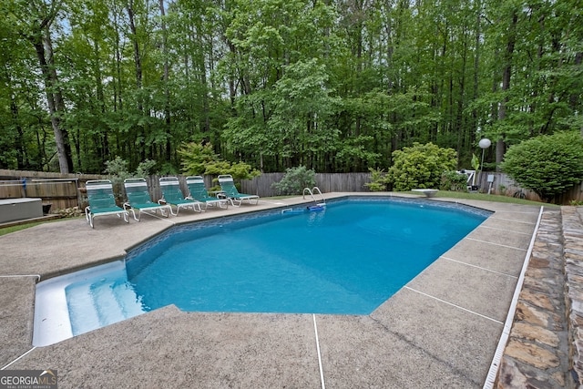 view of pool featuring a fenced in pool, a fenced backyard, and a patio area