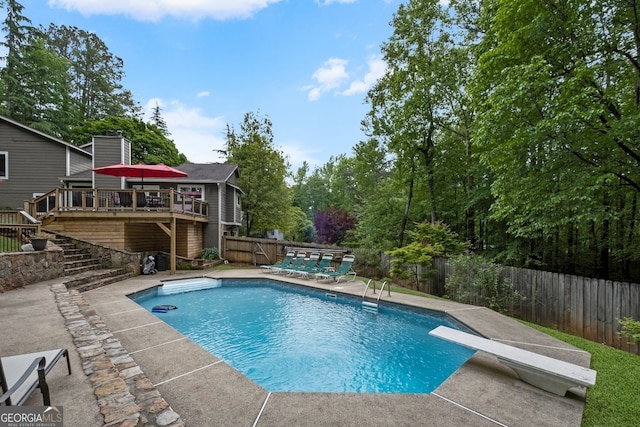 view of pool with a fenced in pool, a deck, a patio area, stairway, and a fenced backyard