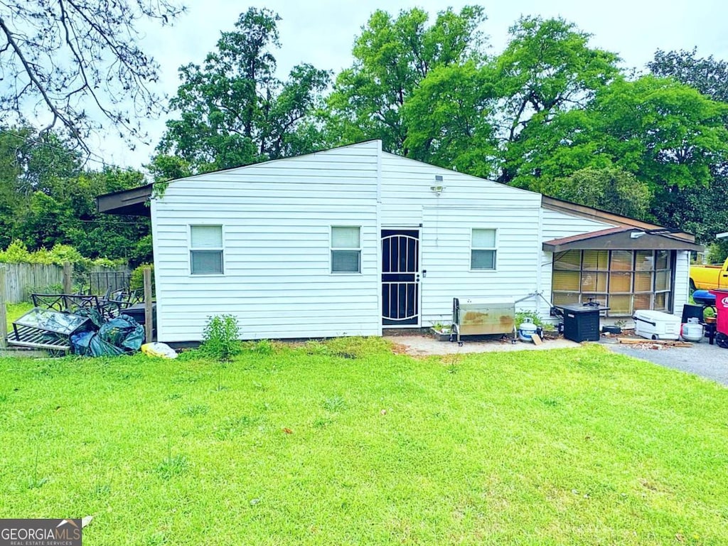 2831 Kent Dr, Macon, GA 31206 - rear view of property with fence, a sunroom, and a yard