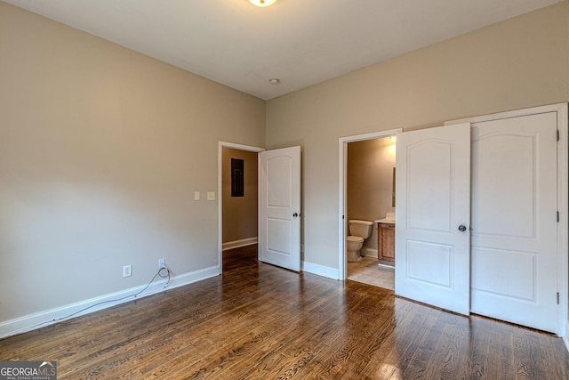683 Pryor St SW Unit C, Atlanta, GA 30315 - unfurnished bedroom featuring wood finished floors, electric panel, baseboards, and connected bathroom