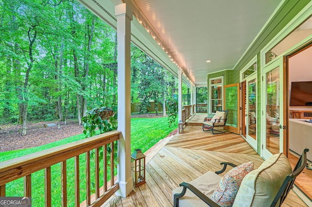 wooden deck featuring a yard