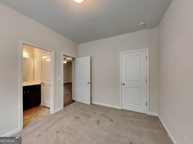 1162 Ida Woods Ln Unit 23, Lawrenceville, GA 30045 - unfurnished bedroom with light carpet, ensuite bath, and baseboards