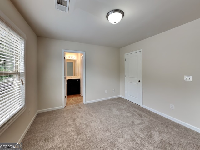 1162 Ida Woods Ln Unit 23, Lawrenceville, GA 30045 - unfurnished bedroom with light colored carpet, baseboards, and ensuite bath