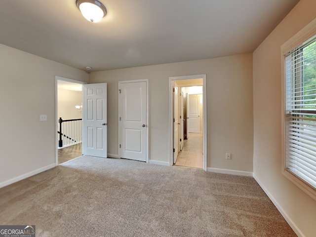 1162 Ida Woods Ln Unit 23, Lawrenceville, GA 30045 - unfurnished bedroom featuring light carpet and baseboards