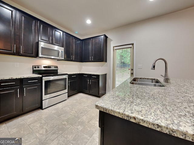 1162 Ida Woods Ln Unit 23, Lawrenceville, GA 30045 - kitchen featuring stainless steel appliances, a sink, light stone countertops, and recessed lighting