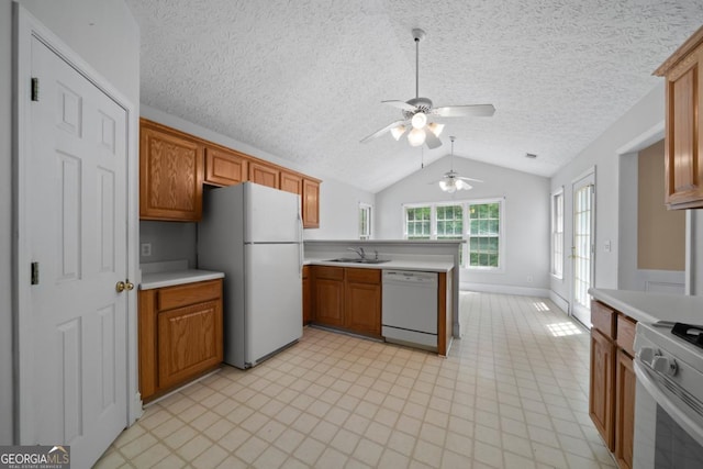 4512 Terret Trce NW, Acworth, GA 30101 - kitchen featuring white appliances, light countertops, lofted ceiling, ceiling fan, and a peninsula