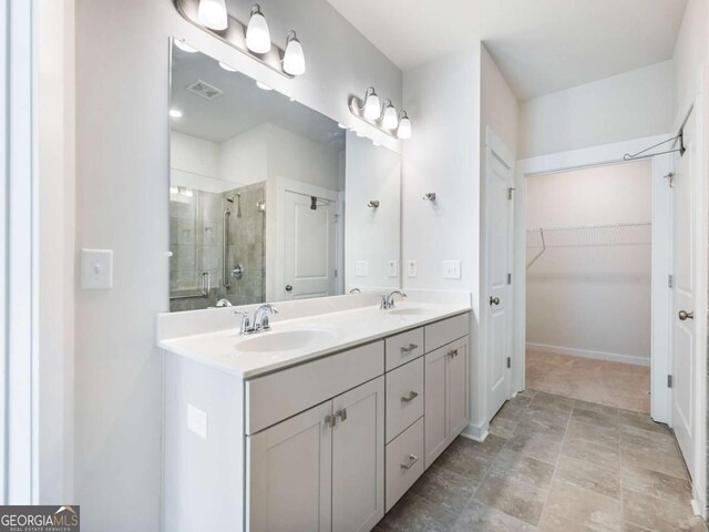 2959 Rambler Dr, Loganville, GA 30052 - full bath with a spacious closet, a sink, double vanity, and a stall shower