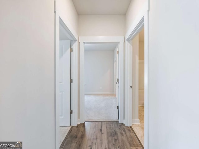 2959 Rambler Dr, Loganville, GA 30052 - hallway with baseboards and wood finished floors
