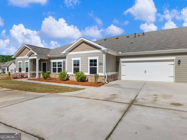 2959 Rambler Dr, Loganville, GA 30052 - view of front facade with brick siding, an attached garage, and concrete driveway