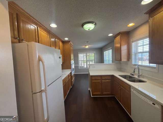 1365 Jubilee Ln, Mcdonough, GA 30253 - kitchen with a sink, dark wood finished floors, recessed lighting, white appliances, and brown cabinets