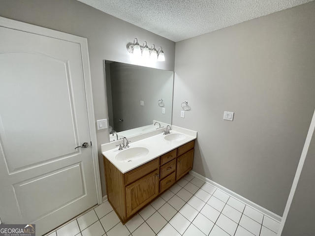 1365 Jubilee Ln, Mcdonough, GA 30253 - bathroom with double vanity, a textured ceiling, tile patterned flooring, and a sink