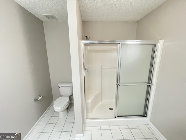 1365 Jubilee Ln, Mcdonough, GA 30253 - full bath featuring visible vents, tile patterned flooring, a shower stall, and toilet