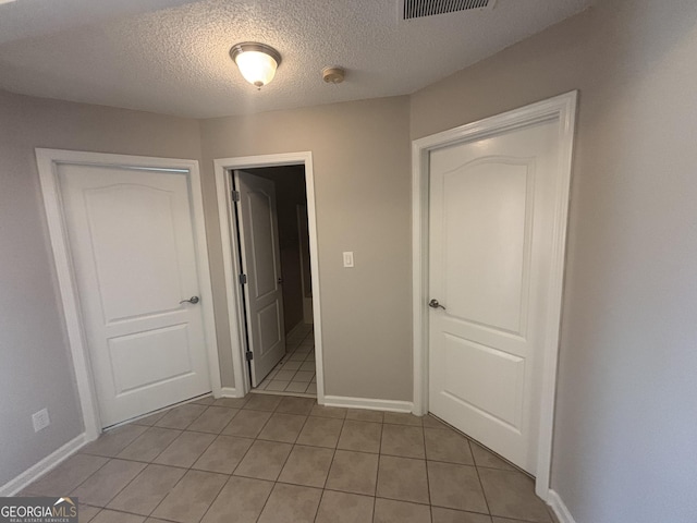 1365 Jubilee Ln, Mcdonough, GA 30253 - unfurnished bedroom with baseboards, visible vents, a textured ceiling, and light tile patterned floors