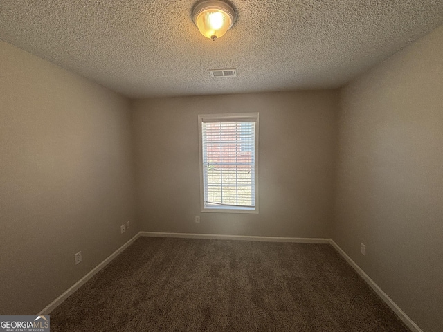 1365 Jubilee Ln, Mcdonough, GA 30253 - unfurnished room featuring a textured ceiling, dark carpet, visible vents, and baseboards