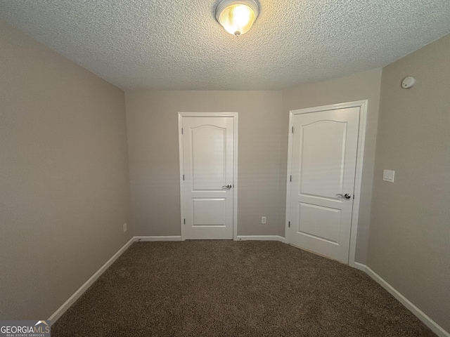 1365 Jubilee Ln, Mcdonough, GA 30253 - unfurnished bedroom featuring baseboards, carpet flooring, and a textured ceiling