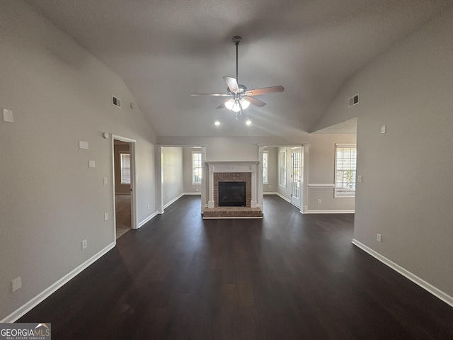 1365 Jubilee Ln, Mcdonough, GA 30253 - unfurnished living room featuring dark wood finished floors, lofted ceiling, visible vents, a ceiling fan, and baseboards