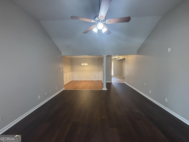 1365 Jubilee Ln, Mcdonough, GA 30253 - unfurnished living room featuring wainscoting, vaulted ceiling, ornate columns, ceiling fan with notable chandelier, and wood finished floors