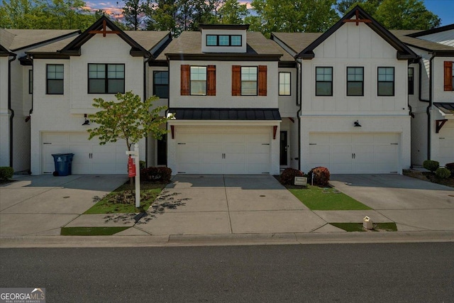 view of property with brick siding, an attached garage, and driveway