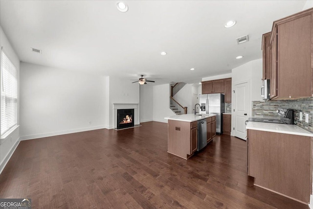 kitchen with a ceiling fan, open floor plan, stainless steel appliances, and visible vents