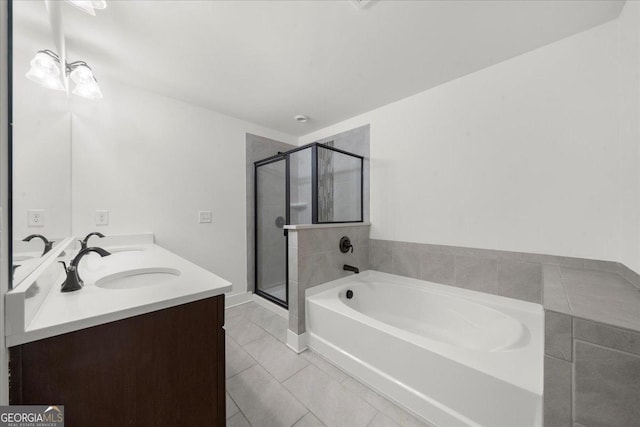 bathroom with a bath, tile patterned floors, a sink, double vanity, and a stall shower