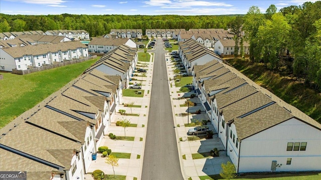 birds eye view of property with a forest view and a residential view