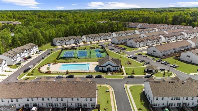 drone / aerial view featuring a wooded view