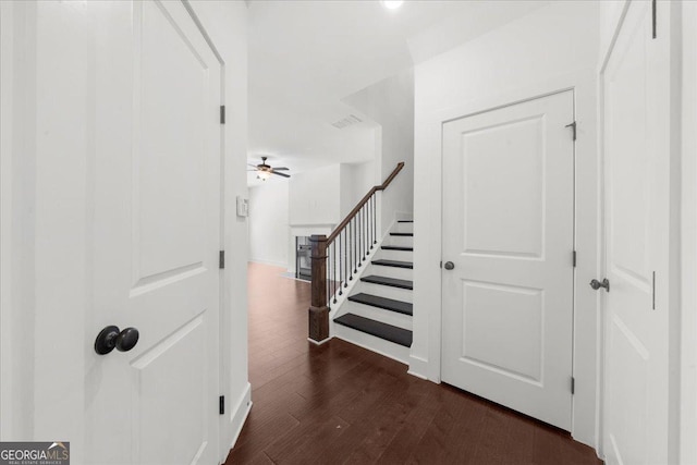 interior space featuring visible vents, stairway, and dark wood finished floors