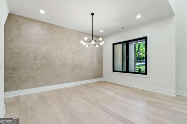 2205 Sugarloaf Pkwy, Lawrenceville, GA 30045 - empty room featuring light wood-style flooring, a chandelier, and recessed lighting