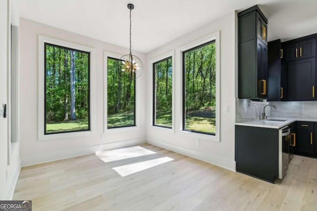 2205 Sugarloaf Pkwy, Lawrenceville, GA 30045 - unfurnished dining area with healthy amount of natural light, light wood-style flooring, and a chandelier