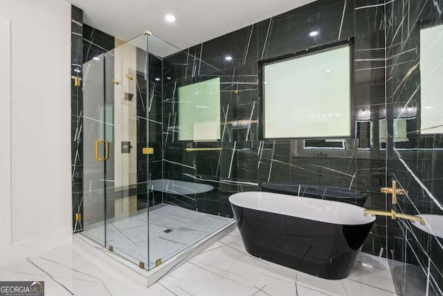2205 Sugarloaf Pkwy, Lawrenceville, GA 30045 - full bathroom featuring a freestanding tub, a stall shower, marble finish flooring, tile walls, and recessed lighting