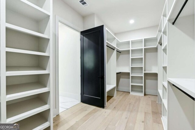 2205 Sugarloaf Pkwy, Lawrenceville, GA 30045 - walk in closet featuring light wood finished floors