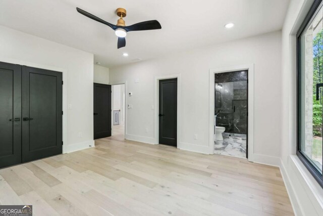 2205 Sugarloaf Pkwy, Lawrenceville, GA 30045 - unfurnished bedroom with light wood-type flooring, multiple windows, recessed lighting, and ensuite bathroom