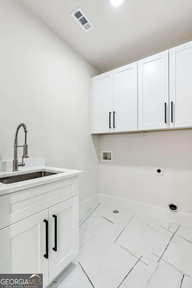 2205 Sugarloaf Pkwy, Lawrenceville, GA 30045 - laundry area with light marble finish flooring, cabinet space, electric dryer hookup, and hookup for a washing machine