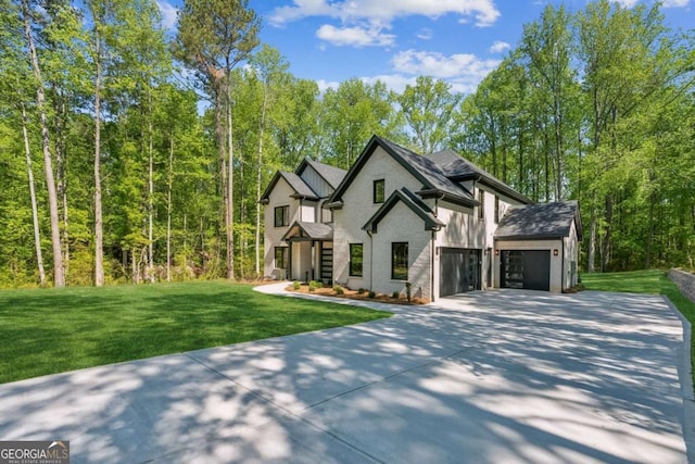 2205 Sugarloaf Pkwy, Lawrenceville, GA 30045 - view of front of property featuring concrete driveway, a front lawn, and an attached garage