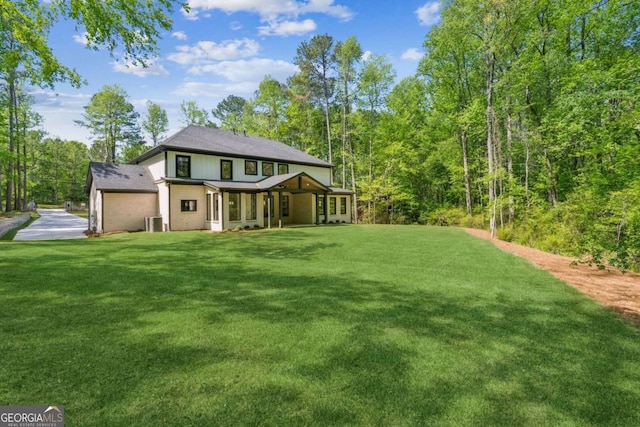 2205 Sugarloaf Pkwy, Lawrenceville, GA 30045 - rear view of property featuring a lawn