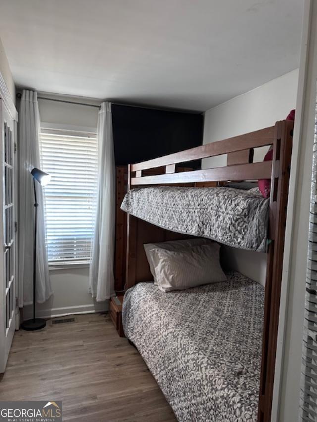 bedroom with wood finished floors and baseboards