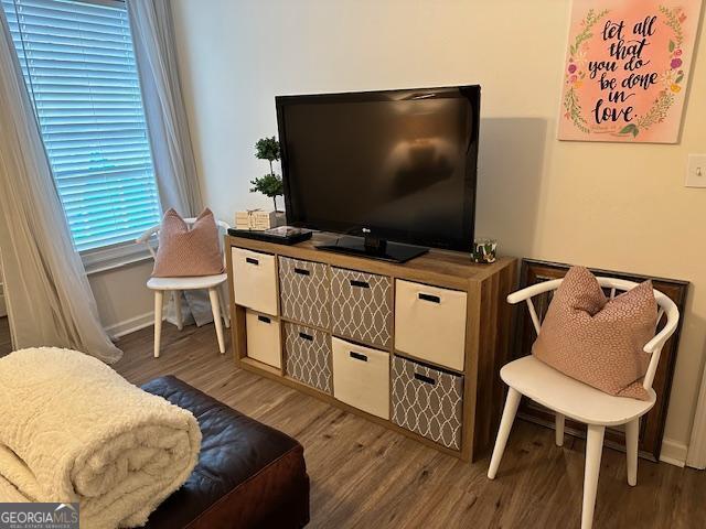 living area with wood finished floors and baseboards