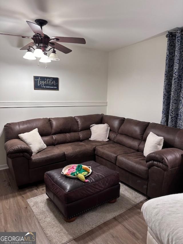 living room featuring light wood-style flooring and ceiling fan