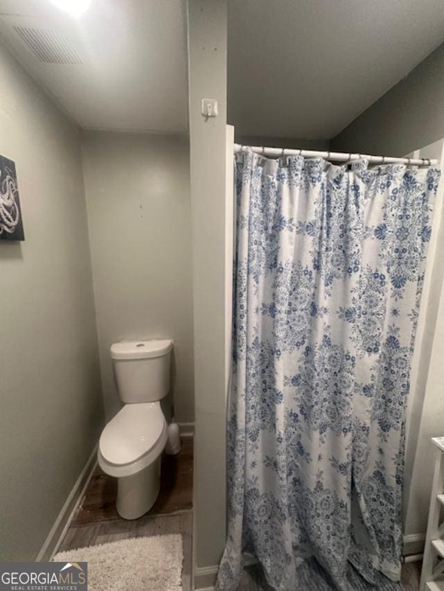 279 S Woods Ct, Jasper, GA 30143 - bathroom featuring toilet, wood finished floors, baseboards, and curtained shower