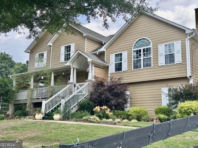 279 S Woods Ct, Jasper, GA 30143 - view of front of property featuring a porch, a chimney, a front yard, and stairs