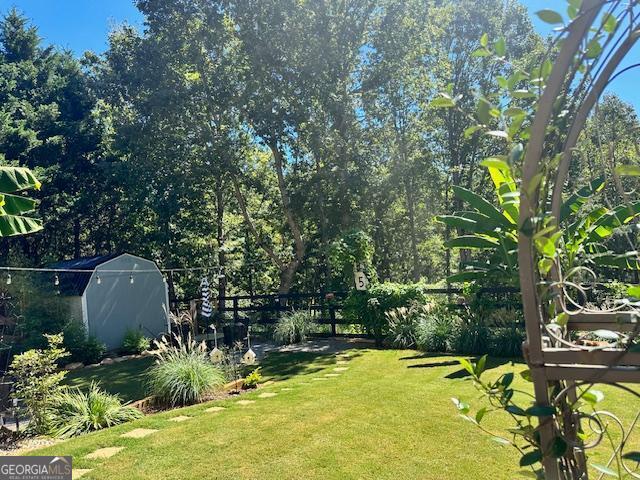 view of yard featuring a shed and an outbuilding
