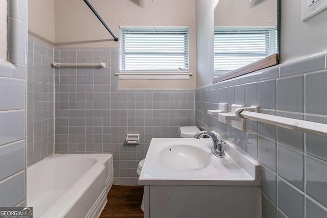 1956 Joseph Ct, Decatur, GA 30032 - full bathroom featuring tile walls, a healthy amount of sunlight, toilet, and vanity