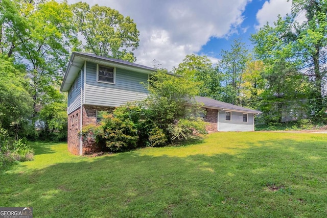 1956 Joseph Ct, Decatur, GA 30032 - back of house with a lawn and brick siding