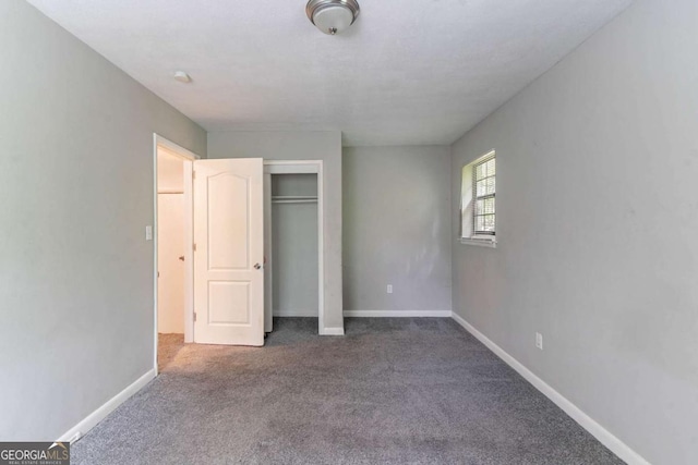 1956 Joseph Ct, Decatur, GA 30032 - unfurnished bedroom with baseboards, carpet flooring, and a closet