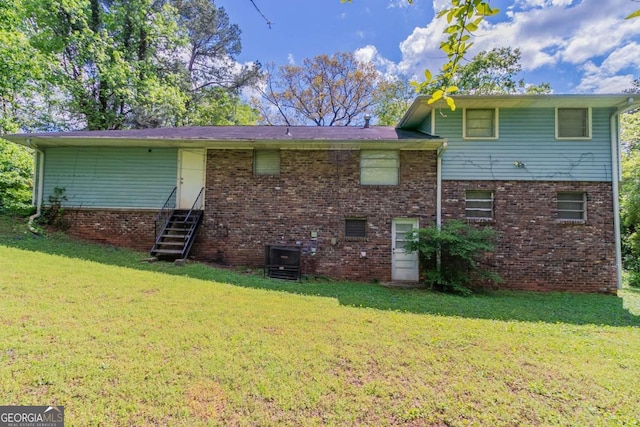 1956 Joseph Ct, Decatur, GA 30032 - rear view of house featuring entry steps, a lawn, and brick siding