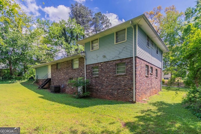 1956 Joseph Ct, Decatur, GA 30032 - rear view of house featuring brick siding, a lawn, and central AC