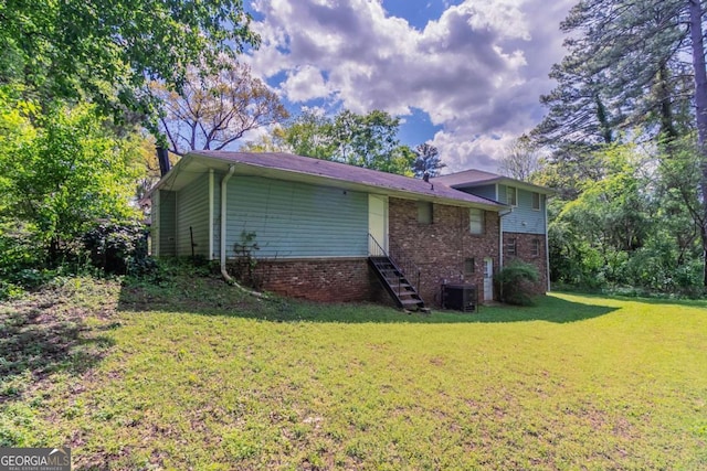 1956 Joseph Ct, Decatur, GA 30032 - rear view of property featuring central air condition unit, brick siding, a yard, and stairway