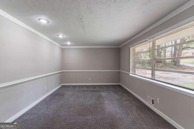 1956 Joseph Ct, Decatur, GA 30032 - unfurnished room with a textured ceiling, baseboards, visible vents, dark carpet, and crown molding